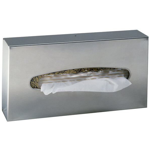 A stainless steel Bobrick surface-mounted tissue dispenser with tissue paper inside.