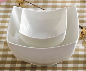 A stack of CAC Super White square porcelain bowls.