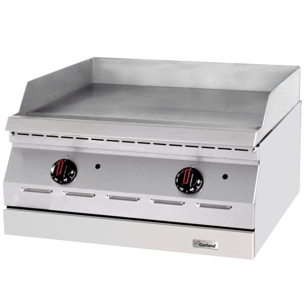 A Garland stainless steel countertop electric griddle with black and red dials.