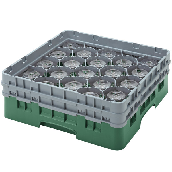 A green and grey plastic Cambro glass rack with clear cups inside.