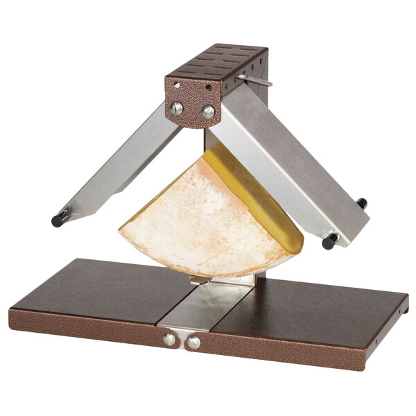 A Bron Coucke raclette machine with a piece of cheese being cut.