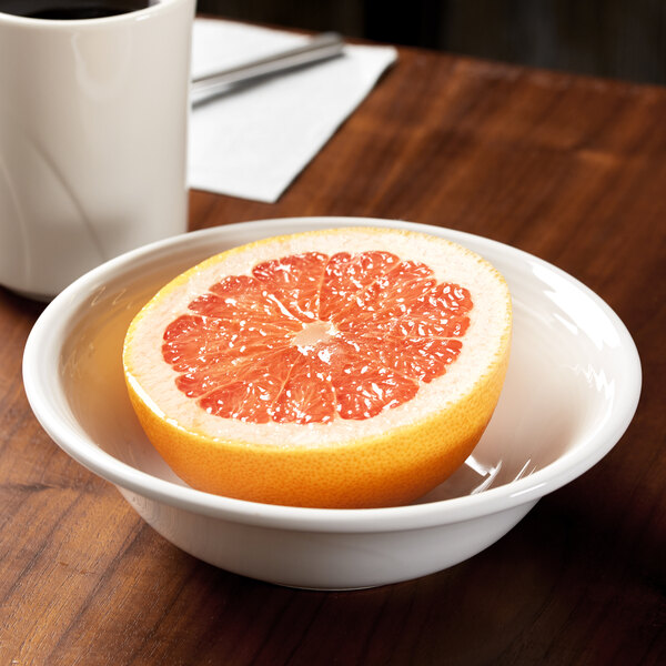 A Reserve by Libbey white porcelain grapefruit bowl with half a grapefruit inside.