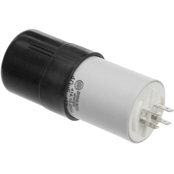 A white and black Champion capacitor with a black plug.