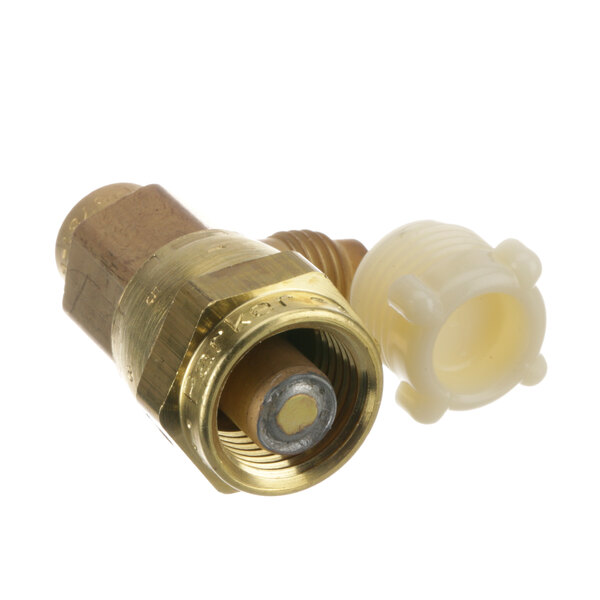 A close-up of a brass Ice-O-Matic coupling with a white plastic cap.