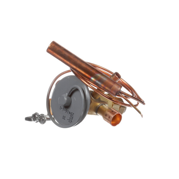 A Master-Bilt expansion valve with a copper pipe, metal connector, and wire.