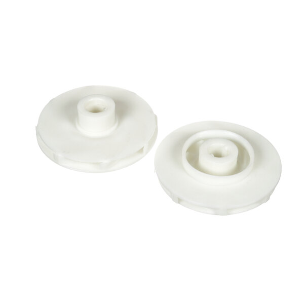 A pair of white plastic wheels with a hole in each one.