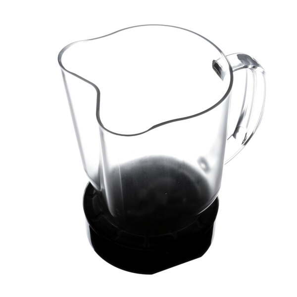 A clear glass pitcher with a handle.