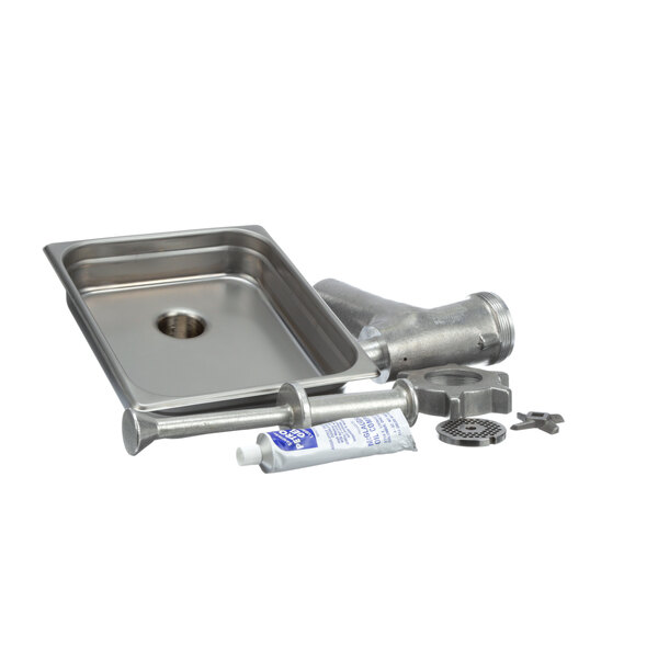 A Univex stainless steel chopper attachment on a counter near a metal sink.