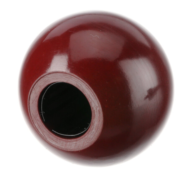 A red ball with a black circle in it.