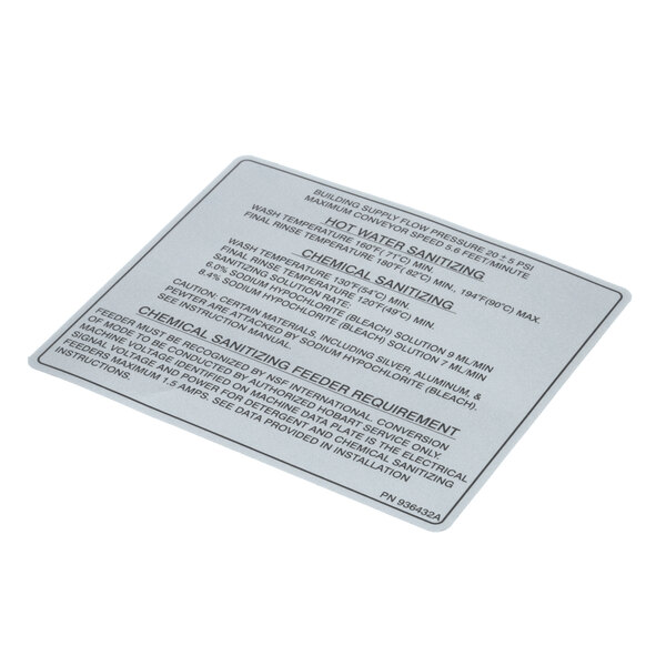 A silver metal label with black text on a white background.