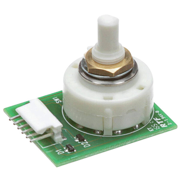 A small green circuit board with a white round knob.