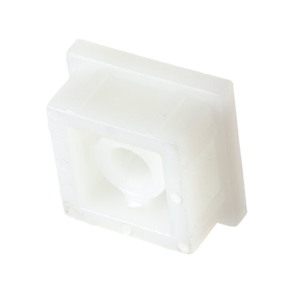 A close-up of a white plastic hinge cap with holes in a square shape.