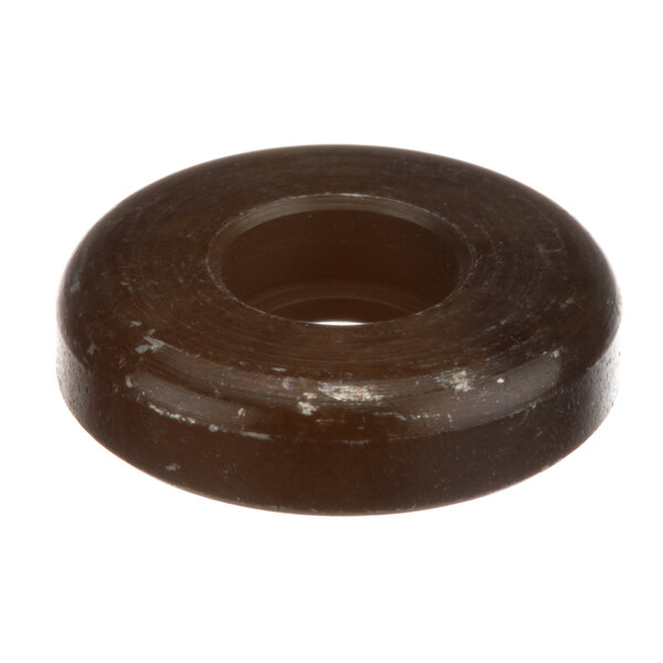 A brown rubber spacer with a hole in it.