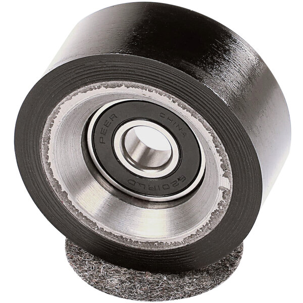 A close-up of a black rubber wheel with a white surface on a Unimac roller and seal kit.
