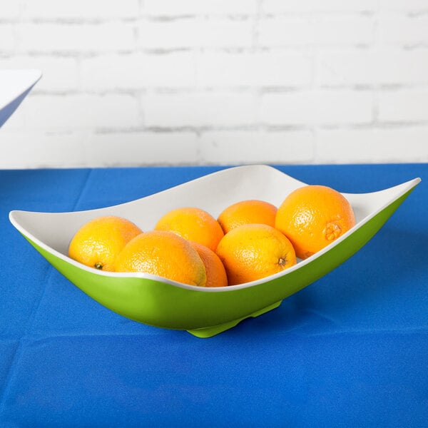 A white Keywest melamine bowl filled with oranges.