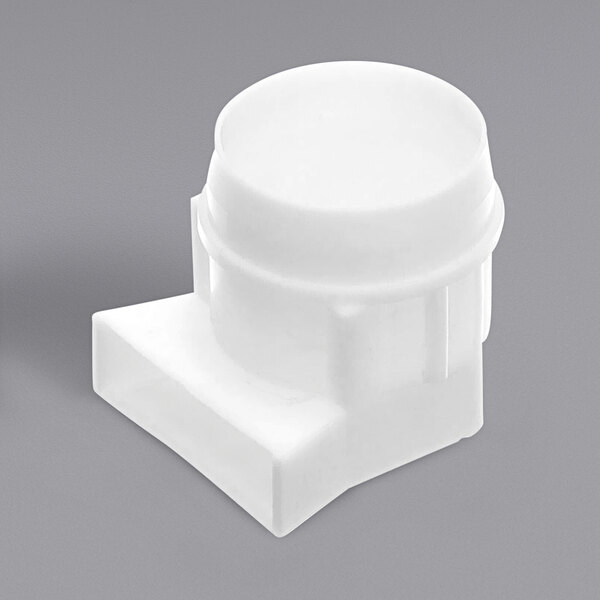 A Traulsen Lamp Cap, a white plastic cap with a hole.