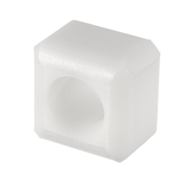 A white plastic cube with a hole in it.