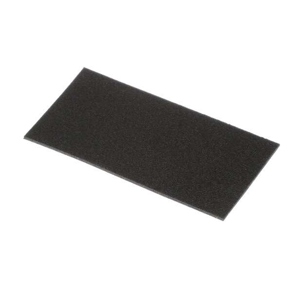 A black rectangular cushion for a SaniServ soft serve machine.