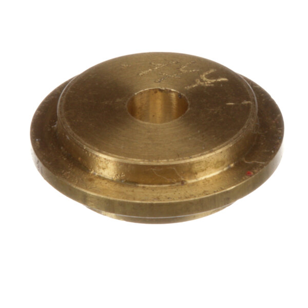 A close-up of a brass Cleveland gas orifice prop with a hole in it.