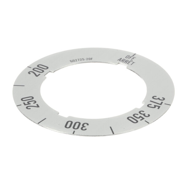 A circular white metal dial insert with black numbers.