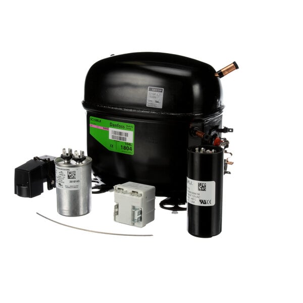 A black and silver Manitowoc Ice compressor with a green label.