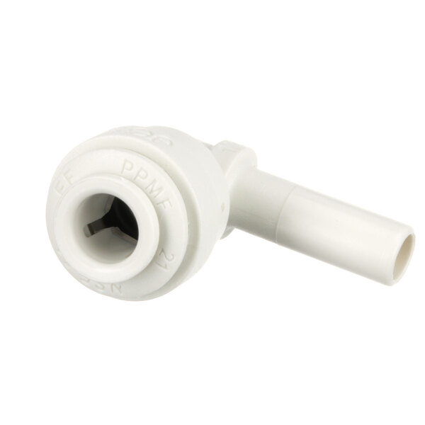 A close-up of a white plastic pipe with a small hole.
