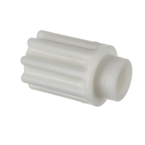 A close-up of a white plastic gear.