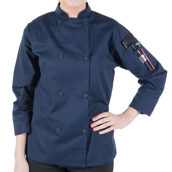 A woman wearing a Mercer Culinary navy blue chef coat.