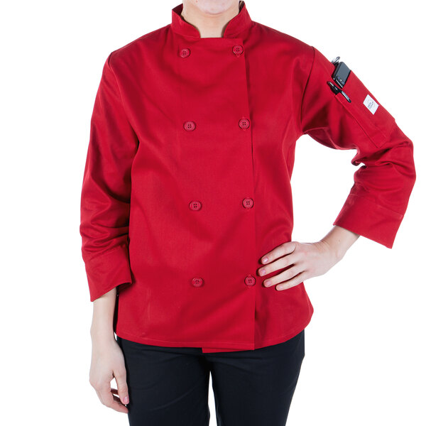 A woman wearing a red Mercer Culinary Millennia chef coat with long sleeves.