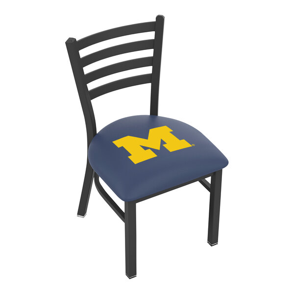 A black steel Holland Bar Stool chair with a University of Michigan logo on the padded blue seat and ladder back.