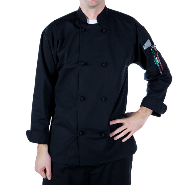 A man wearing a Mercer Culinary black long sleeve chef jacket with cloth knot buttons.