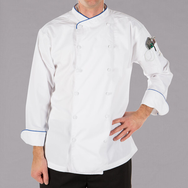 A man wearing a white Mercer Culinary chef's coat with royal blue piping.