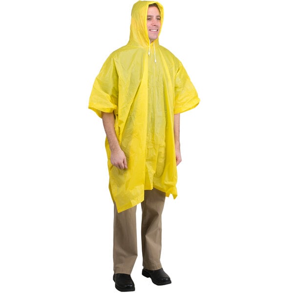 A man wearing a yellow Cordova rain poncho.