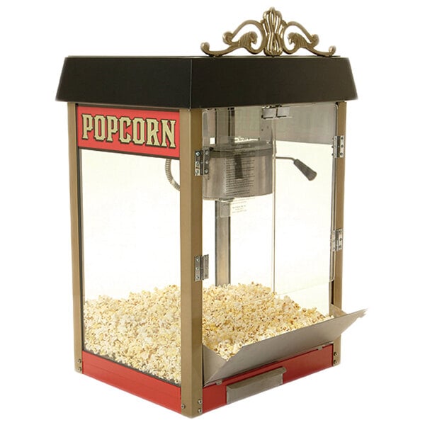 A red Benchmark USA popcorn machine with popcorn in it.