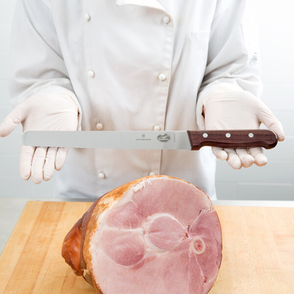 Chef Slicing Roast Beef Using Carving Knife And Fork Stock Photo