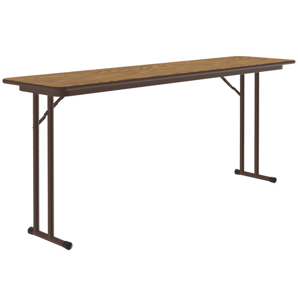 A Correll medium oak seminar table with off-set legs and a brown metal frame.
