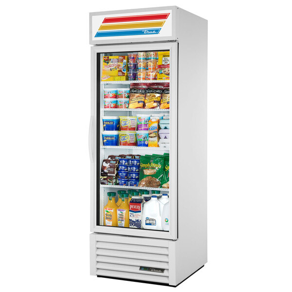 A white True glass door refrigerator filled with food.