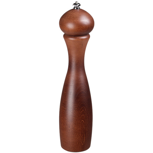 A Fletchers' Mill Marsala walnut stain pepper mill with a silver top on a table in a home kitchen.