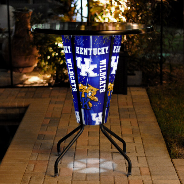 A Holland Bar Stool University of Kentucky 36" Round LED Pub Table with a blue and white University of Kentucky logo on it.