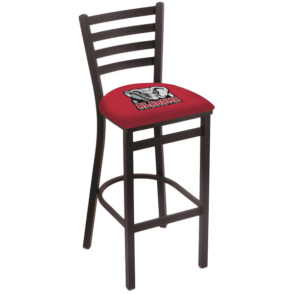 A black steel bar stool with a red cushion featuring the University of Alabama logo.