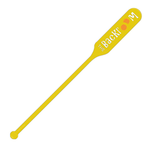A yellow paddle stirrer with white text reading "Spirit" on it.