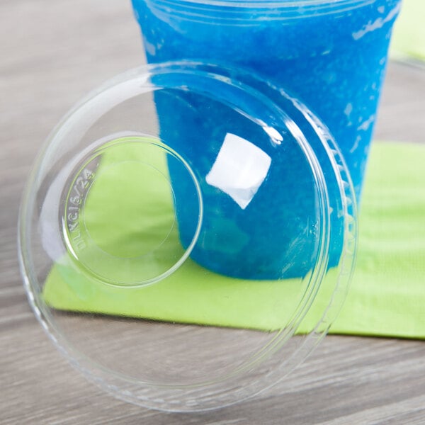 A plastic cup with a Fabri-Kal clear dome lid and a blue drink.