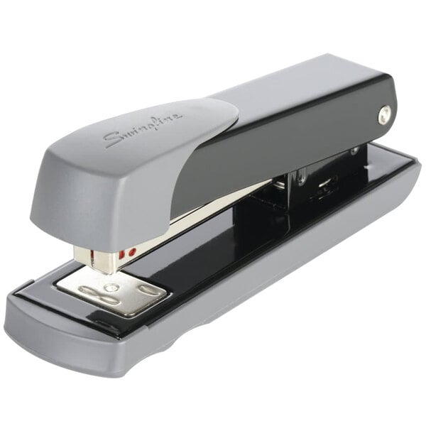 A close-up of a black and grey Swingline Compact stapler.