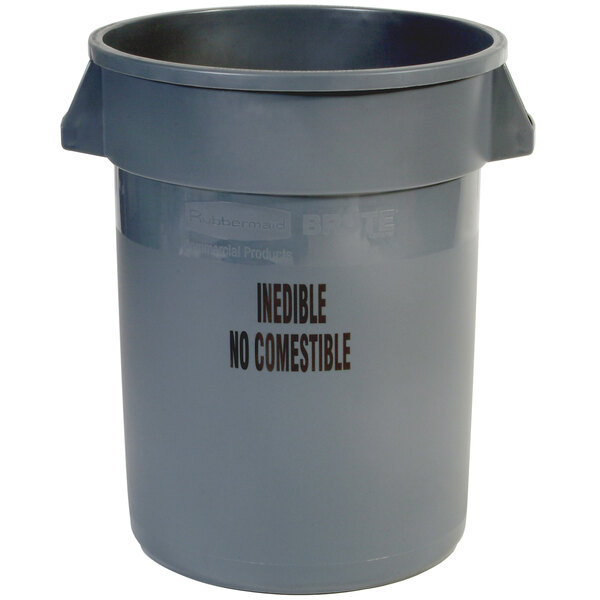 A grey plastic trash can with black "Inedible" text.