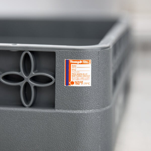 A grey plastic container with a white and orange Taylor TempRite sticker.