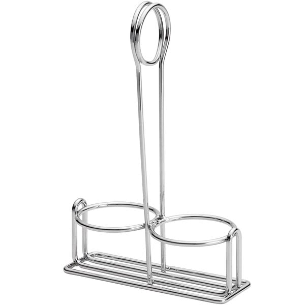 A silver metal Tablecraft cruet rack holding two round objects.