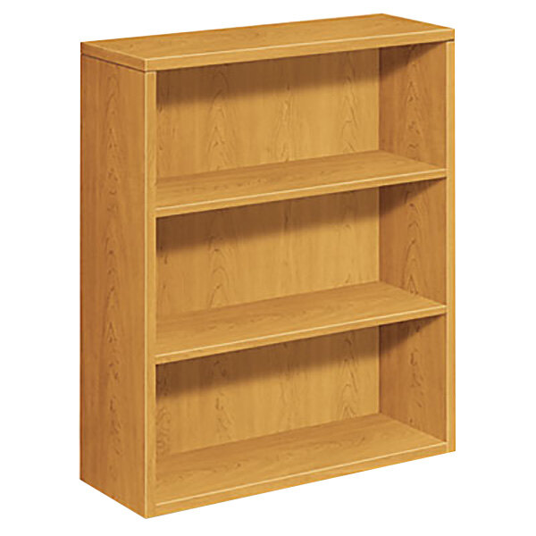A HON laminate wood bookcase with three shelves.