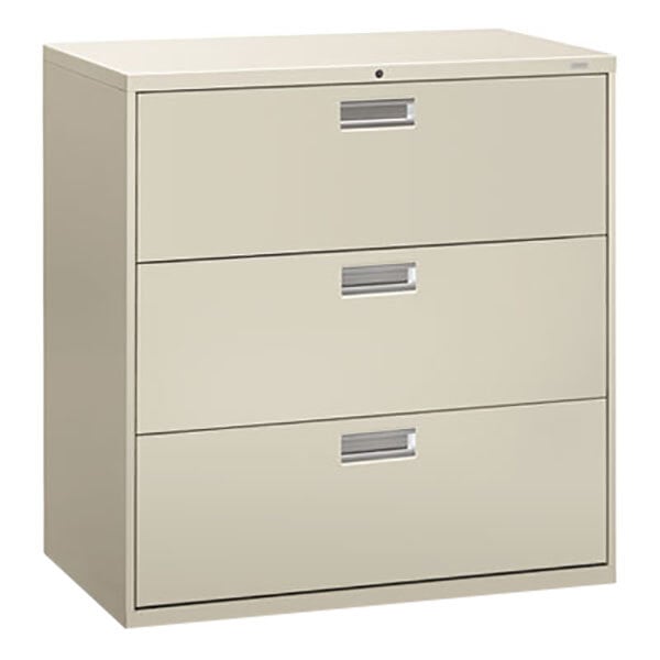 A light gray HON 600 Series three-drawer lateral filing cabinet.