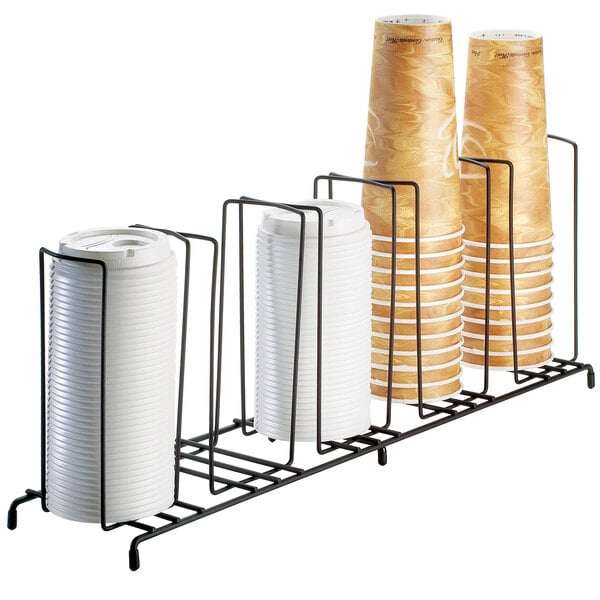 A black iron Cal-Mil countertop cup and lid organizer with 5 sections holding cups.