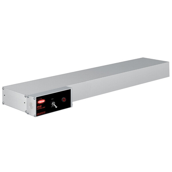 A long rectangular stainless steel Hatco food warmer with a black box and red light.